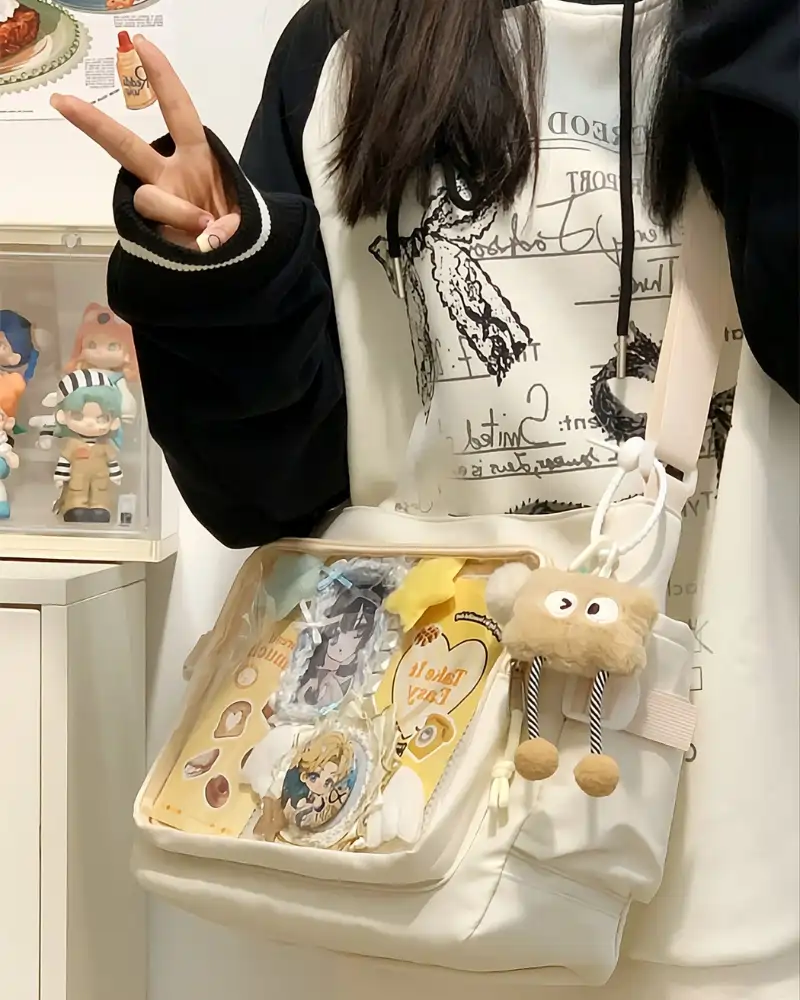 Premium ita bag with large transparent clear window displaying colorful enamel pins and anime charms - perfect kawaii crossbody ita bag for pin collectors